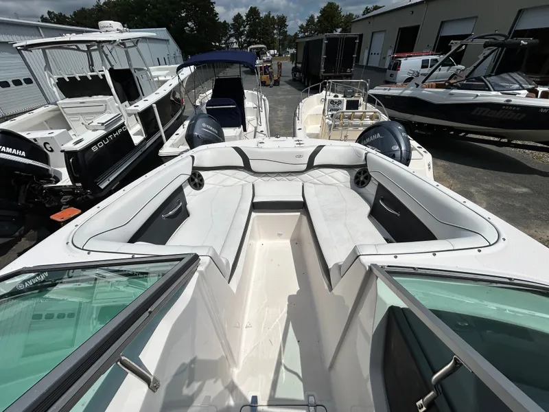 Slide: The Image of The image shows the bow area of a 2018 Regal 23 OBX boat with white upholstery. - 17