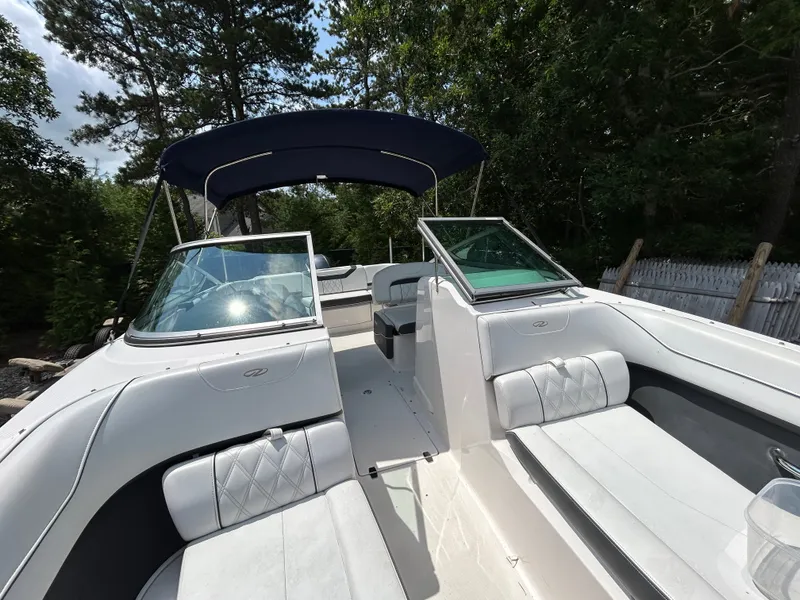 Slide: The Image of The image shows a 2018 Regal 23 OBX boat with white upholstery and a blue sunshade. - 20