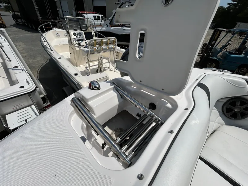 Slide: The Image of A 2018 Regal 23 OBX boat featuring an integrated swim ladder and open deck area. - 18