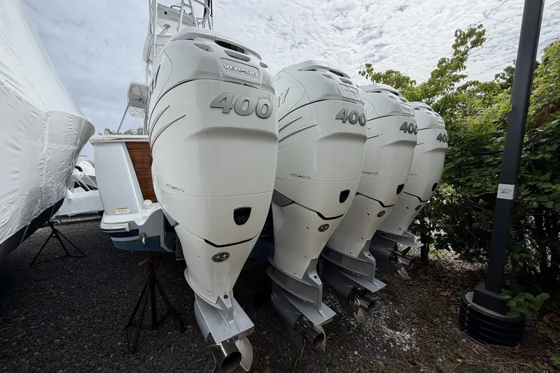 Slide: The Image of Four powerful outboard engines on a 2022 Valhalla Boatworks V-41, parked outdoors. - 6