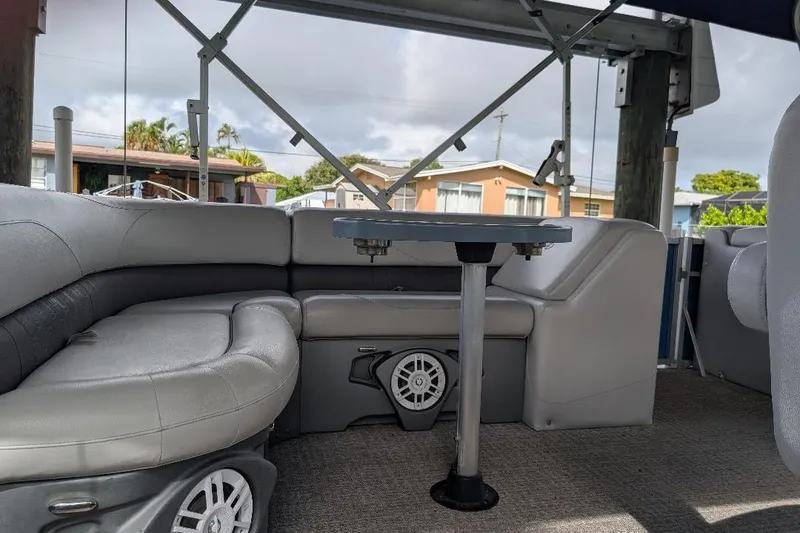 Slide: The Image of Interior of a 2019 Avalon 2485LSZ pontoon boat with gray seating and table. - 8