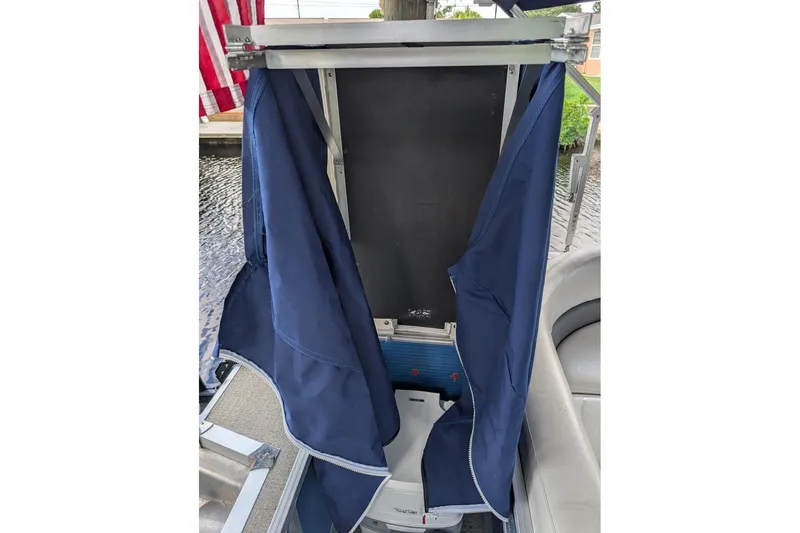 Slide: The Image of 2019 Avalon 2485LSZ boat interior with blue cover and American flag in background. - 11