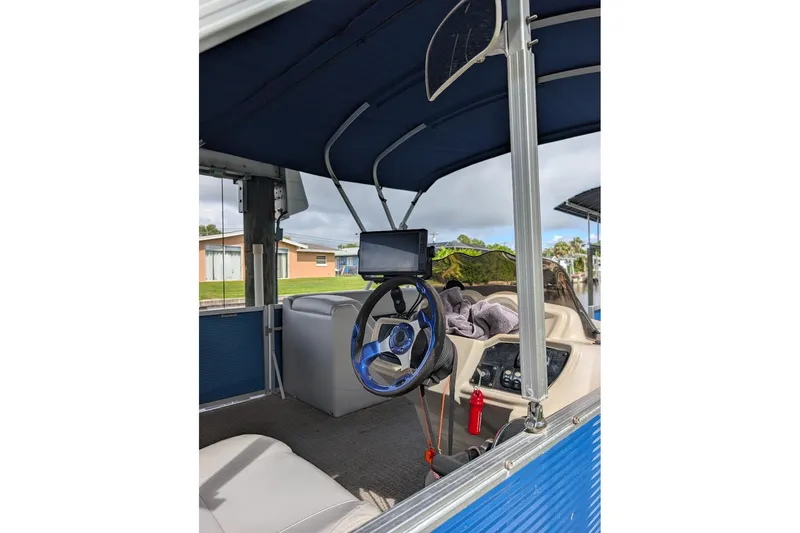 Slide: The Image of Interior of a 2019 Avalon 2485LSZ pontoon boat with steering wheel and dashboard. - 4