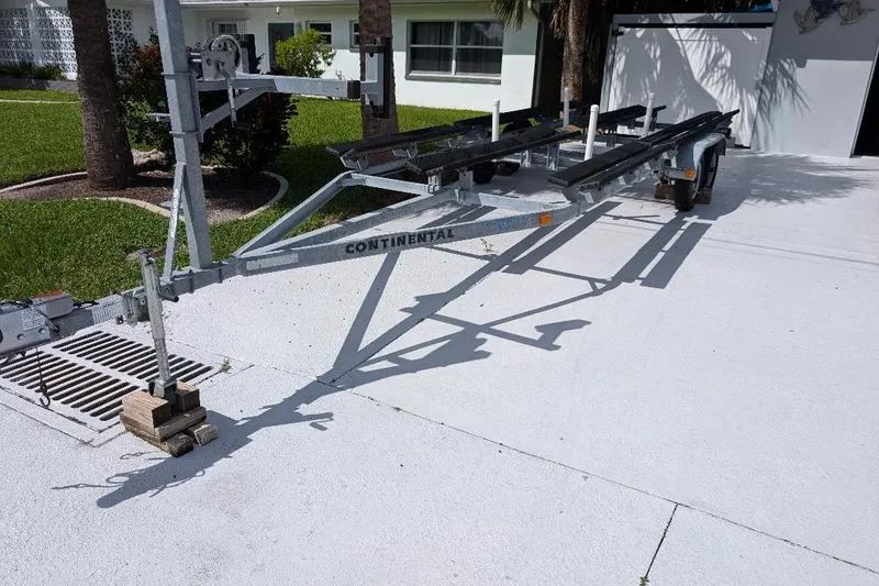 Slide: The Image of Trailer for 2019 Avalon 2485LSZ boat parked on a driveway. - 16