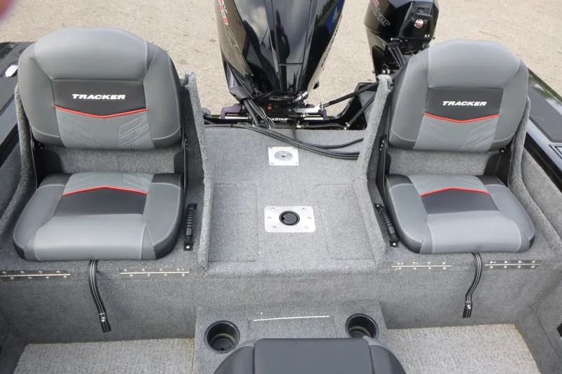 Slide: The Image of 2023 Tracker Targa V-19 Combo boat interior with dual gray seats and motor. - 15