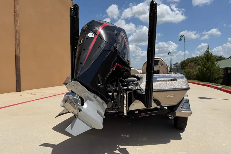 Slide: The Image of 2026 Ranger Z521R Ultra boat with powerful outboard motor, parked outdoors under a blue sky. - 7