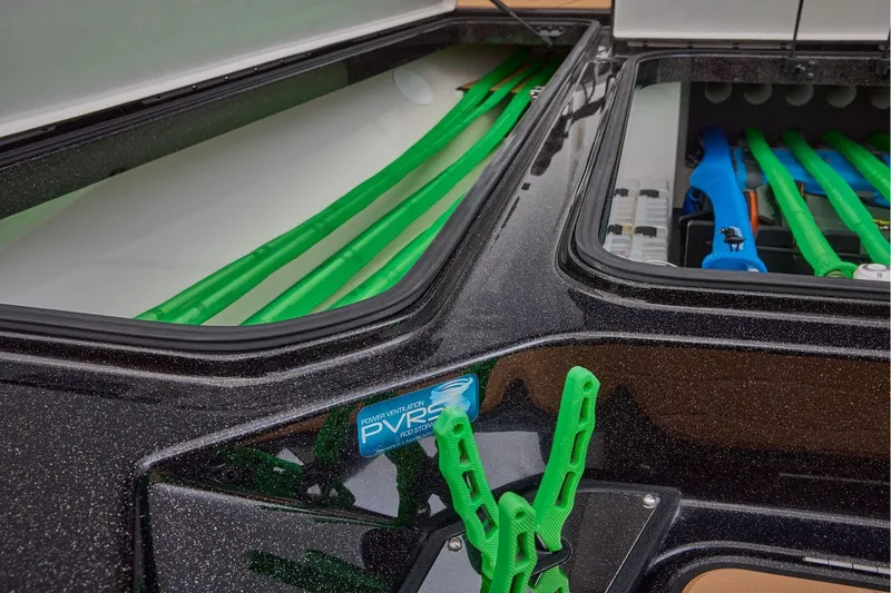 Slide: The Image of Manufacturer Provided Image: 2026 Ranger Z521R ULTRA boat storage compartments with green and blue rod holders. - 30