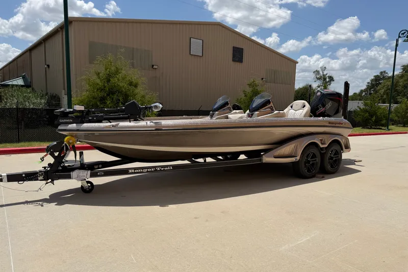Slide: The Image of 2026 Ranger Z521R Ultra boat on trailer, parked outdoors under a partly cloudy sky. - 8