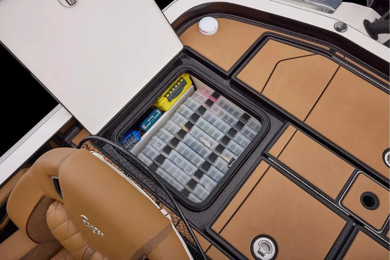 Slide: The Image of Manufacturer Provided Image: 2026 Ranger Z521R ULTRA boat storage compartment with organized tackle boxes and tan seating. - 60