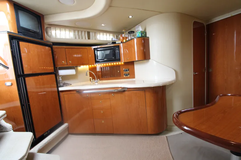 Slide: The Image of Luxurious 2001 Sea Ray 380 Sundancer yacht interior with kitchenette and wood finish. - 30