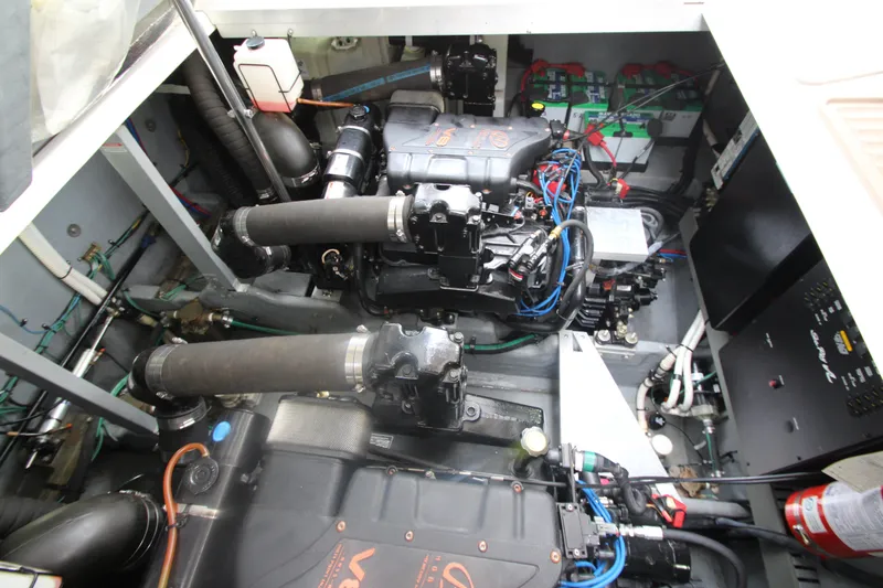 Slide: The Image of Engine compartment of a 2001 Sea Ray 380 Sundancer, showcasing mechanical components and wiring. - 53