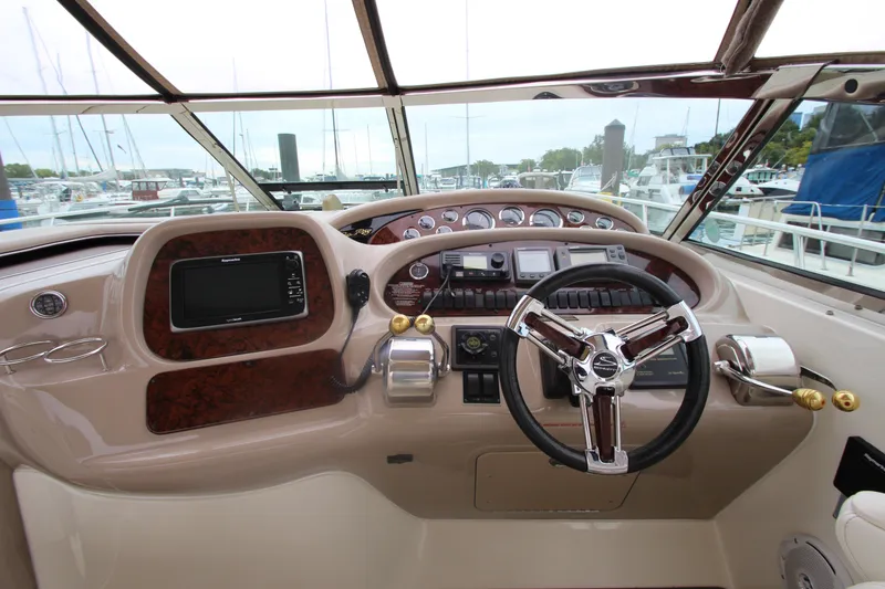 Slide: The Image of Helm of 2001 Sea Ray 380 Sundancer with steering wheel and navigation controls. - 24