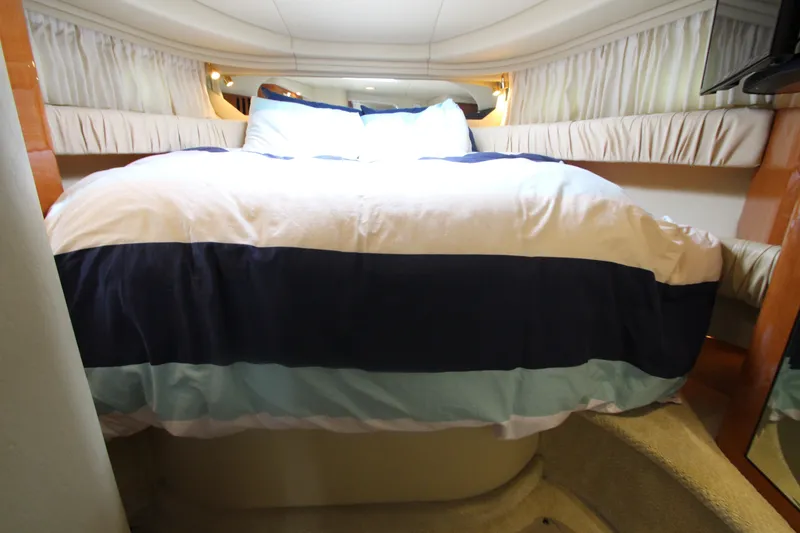Slide: The Image of Cozy bedroom interior of 2001 Sea Ray 380 Sundancer yacht with striped bedding. - 39