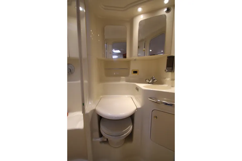 Slide: The Image of 2001 Sea Ray 380 Sundancer bathroom with sink, toilet, and mirror in compact design. - 40