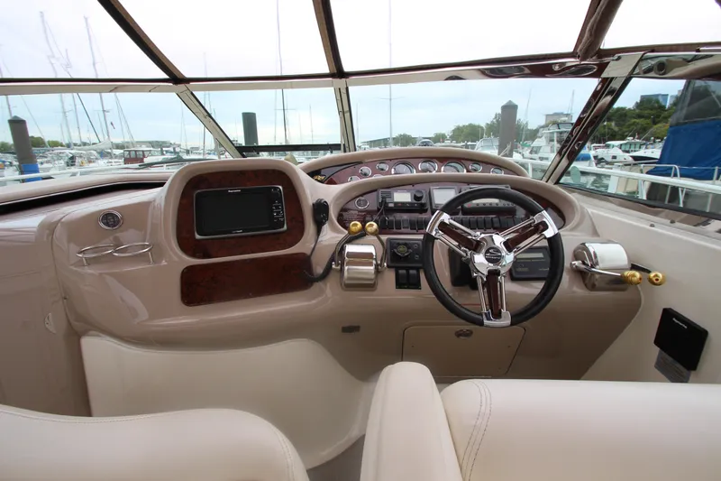 Slide: The Image of Helm of 2001 Sea Ray 380 Sundancer with steering wheel and navigation controls. - 18
