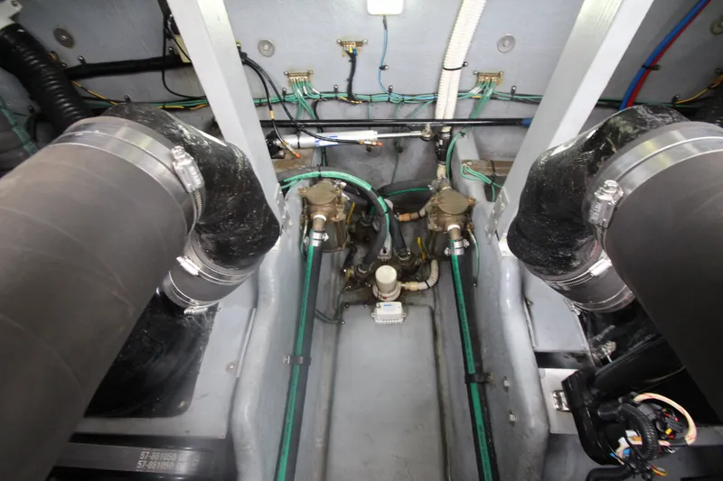 Slide: The Image of Engine compartment of a 2001 Sea Ray 380 Sundancer boat, showcasing hoses and wiring. - 52