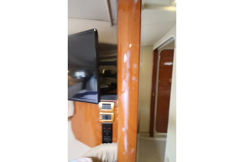 Slide: The Image of Interior view of 2001 Sea Ray 380 Sundancer yacht with TV and wood paneling. - 37