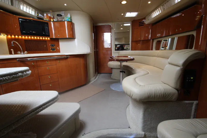Slide: The Image of Luxurious interior of a 2001 Sea Ray 380 Sundancer yacht with elegant seating and kitchen area. - 27