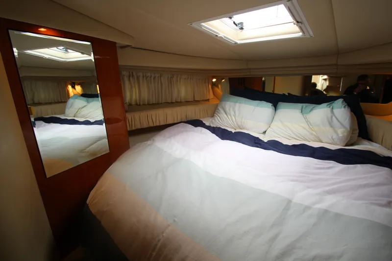 Slide: The Image of Cozy bedroom interior of 2001 Sea Ray 380 Sundancer yacht with skylight and mirror. - 34