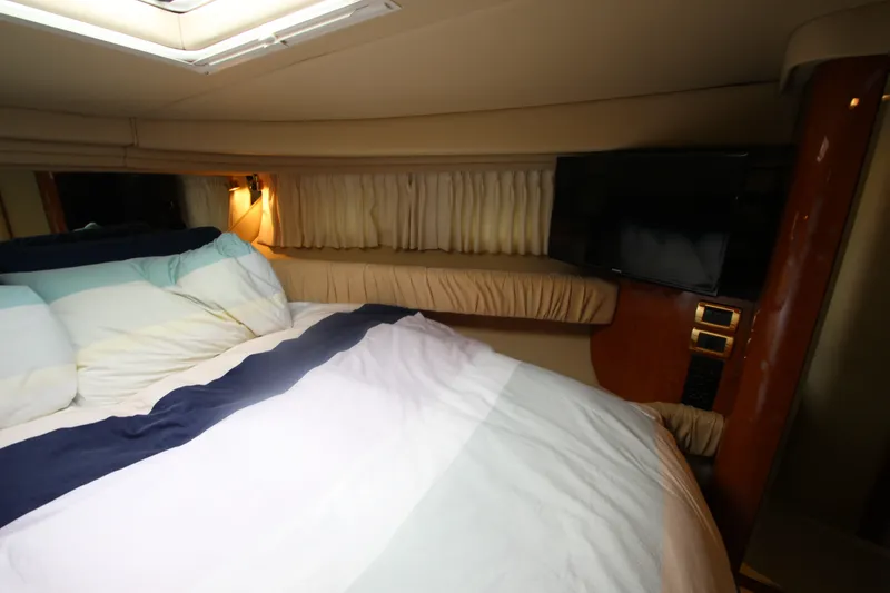 Slide: The Image of Cozy cabin interior of 2001 Sea Ray 380 Sundancer with bed and TV. - 35