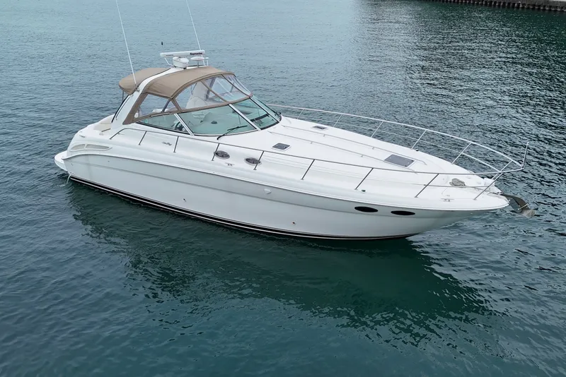 The Image of 2001 Sea Ray 380 Sundancer yacht on calm water, showcasing sleek design and luxury features. - 1