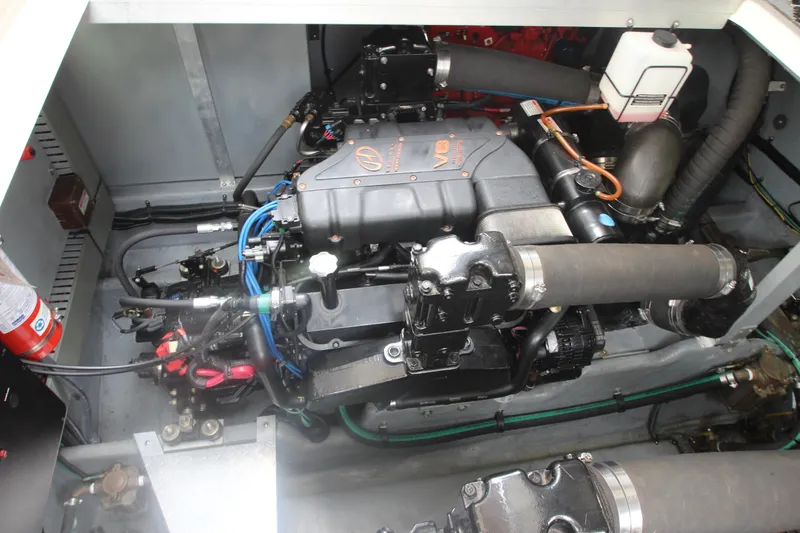 Slide: The Image of Engine compartment of a 2001 Sea Ray 380 Sundancer boat, showcasing V8 engine components. - 55