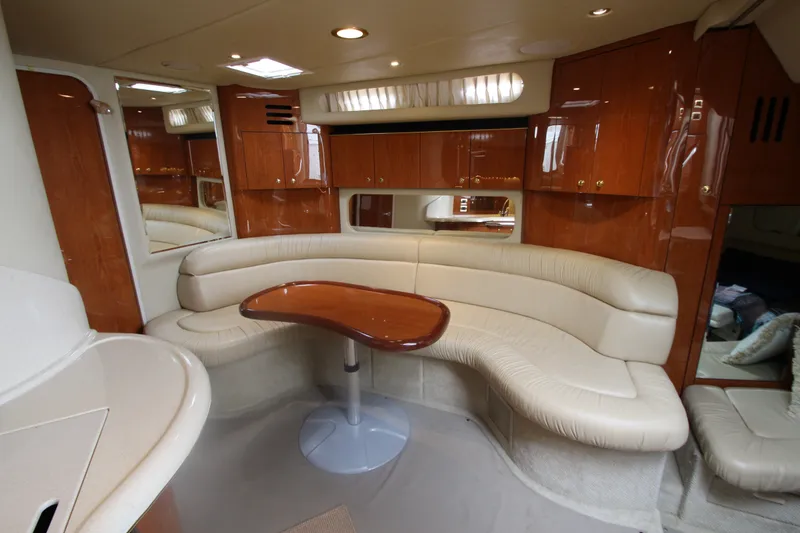 Slide: The Image of Luxurious interior of 2001 Sea Ray 380 Sundancer yacht with curved seating and wooden cabinetry. - 31