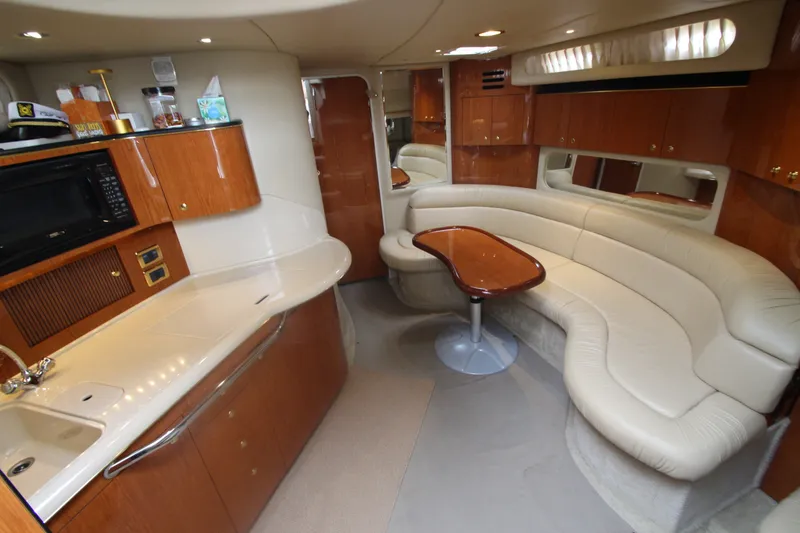 Slide: The Image of Luxurious interior of 2001 Sea Ray 380 Sundancer yacht with kitchen and seating area. - 26