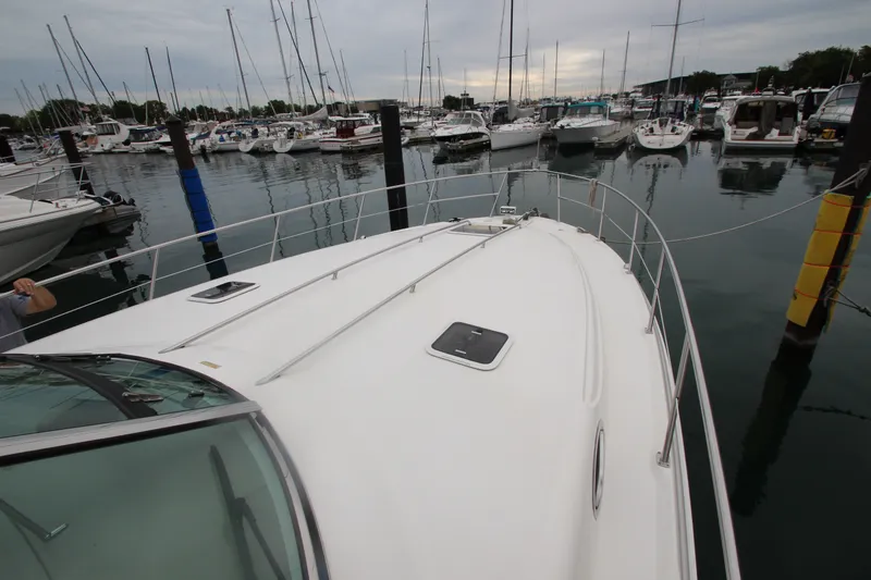 Slide: The Image of 2001 Sea Ray 380 Sundancer yacht docked in a marina with other boats. - 15