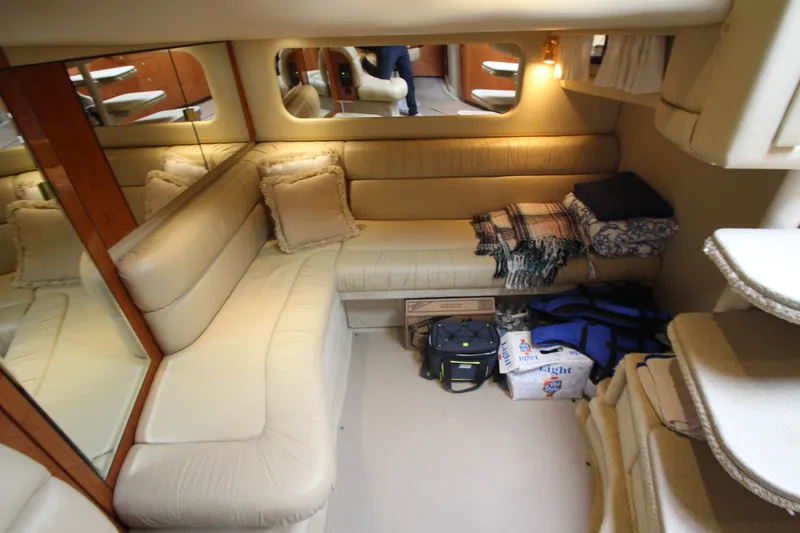 Slide: The Image of Interior of 2001 Sea Ray 380 Sundancer yacht with beige seating and storage items. - 47