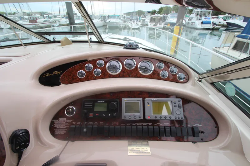 Slide: The Image of Control panel of a 2001 Sea Ray 380 Sundancer yacht at a marina. - 23