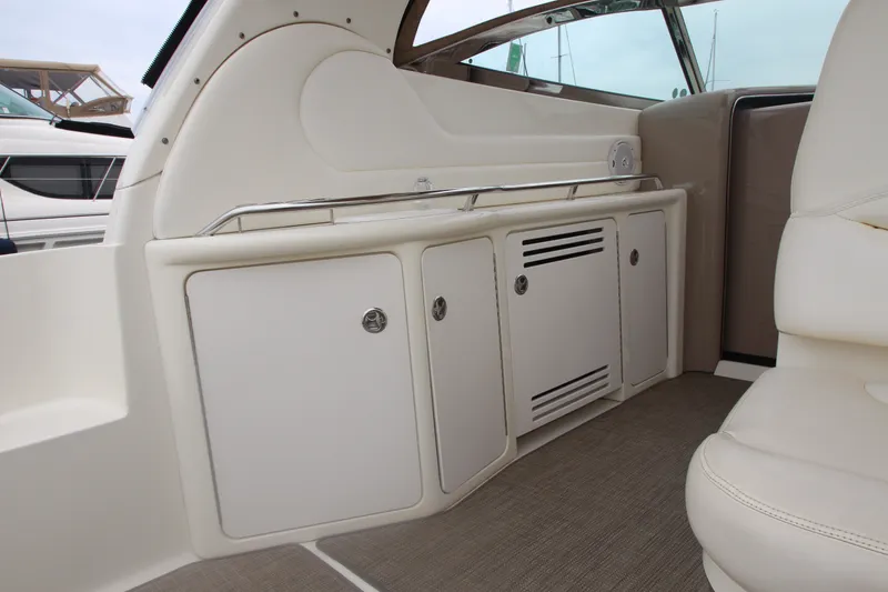 Slide: The Image of Interior view of a 2001 Sea Ray 380 Sundancer yacht, featuring sleek cabinetry and seating. - 20