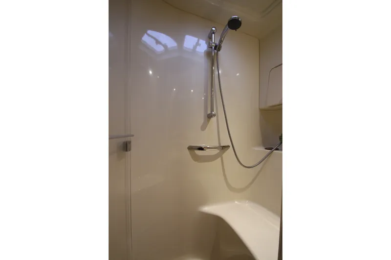 Slide: The Image of Shower area in 2001 Sea Ray 380 Sundancer yacht, featuring a handheld showerhead and seating. - 42
