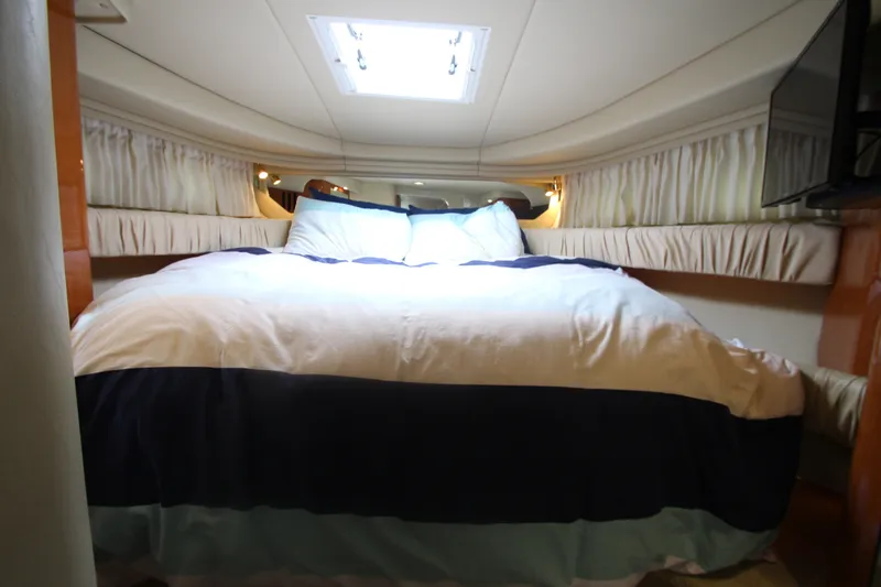 Slide: The Image of Luxurious cabin interior of 2001 Sea Ray 380 Sundancer yacht with cozy bedding. - 38
