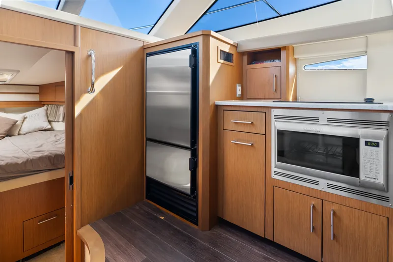 Slide: The Image of Interior of 2012 Carver 41 Cockpit Motor Yacht with kitchen and cozy bedroom. - 31