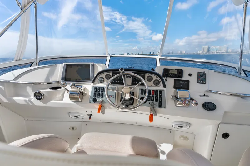 Slide: The Image of Cockpit view of 2012 Carver 41 Cockpit Motor Yacht with ocean backdrop. - 12