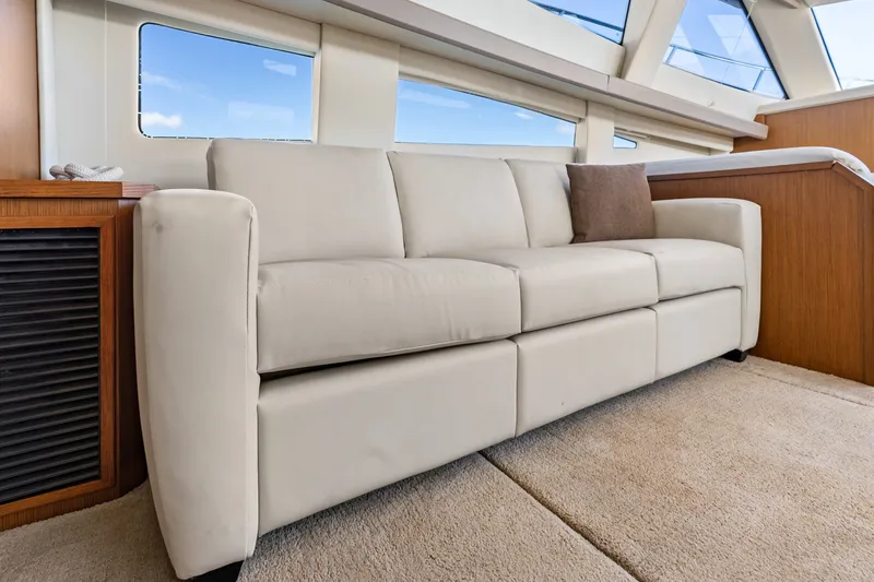 Slide: The Image of Luxurious interior of 2012 Carver 41 Cockpit Motor Yacht with beige sofa and large windows. - 34