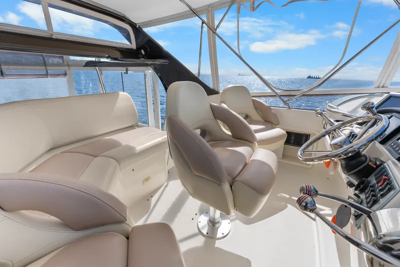 Slide: The Image of Luxurious 2012 Carver 41 Cockpit Motor Yacht interior with plush seating and ocean view. - 15