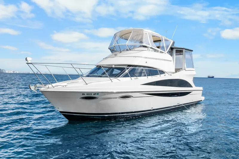 Slide: The Image of 2012 Carver 41 Cockpit Motor Yacht cruising on open water under blue skies. - 5