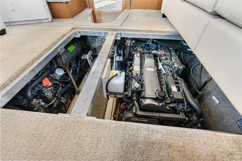 Slide: The Image of Engine compartment of a 2012 Carver 41 Cockpit Motor Yacht, showcasing dual engines. - 48