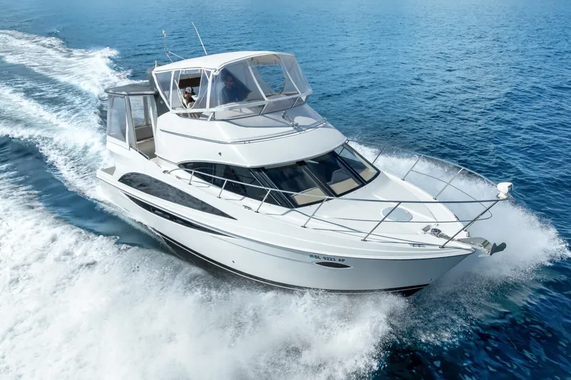 Slide: The Image of 2012 Carver 41 Cockpit Motor Yacht cruising on open water. - 8