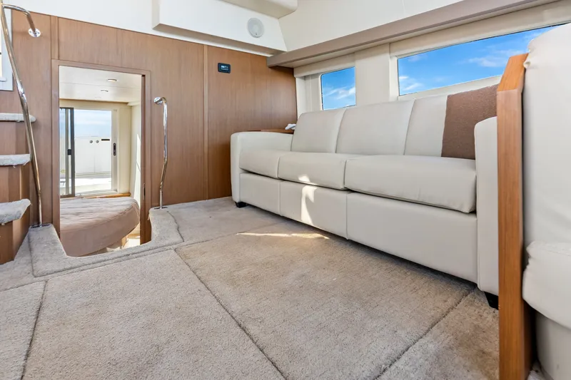 Slide: The Image of Luxurious interior of 2012 Carver 41 Cockpit Motor Yacht with plush seating and carpeted flooring. - 25