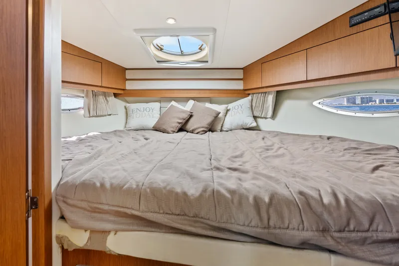 Slide: The Image of Luxurious bedroom interior of 2012 Carver 41 Cockpit Motor Yacht with cozy bedding. - 43
