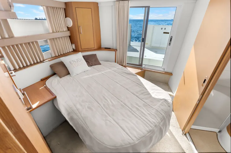 Slide: The Image of Interior of 2012 Carver 41 Cockpit Motor Yacht bedroom with ocean view. - 44