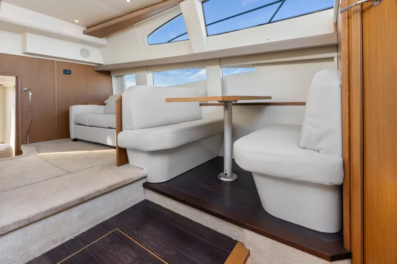 Slide: The Image of Interior of 2012 Carver 41 Cockpit Motor Yacht with plush seating and dining area. - 33