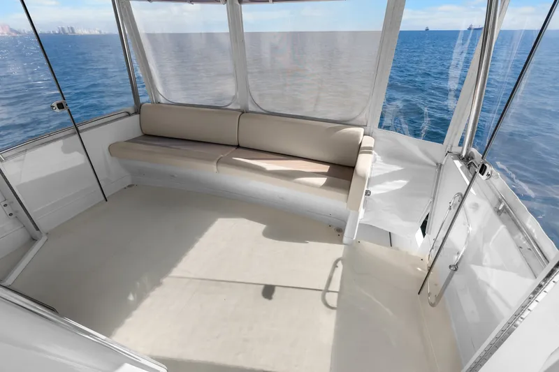 Slide: The Image of 2012 Carver 41 Cockpit Motor Yacht interior with ocean view and seating area. - 19