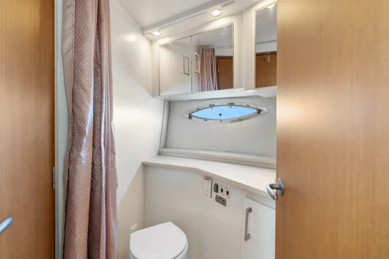 Slide: The Image of Bathroom interior of 2012 Carver 41 Cockpit Motor Yacht with porthole and modern fixtures. - 42