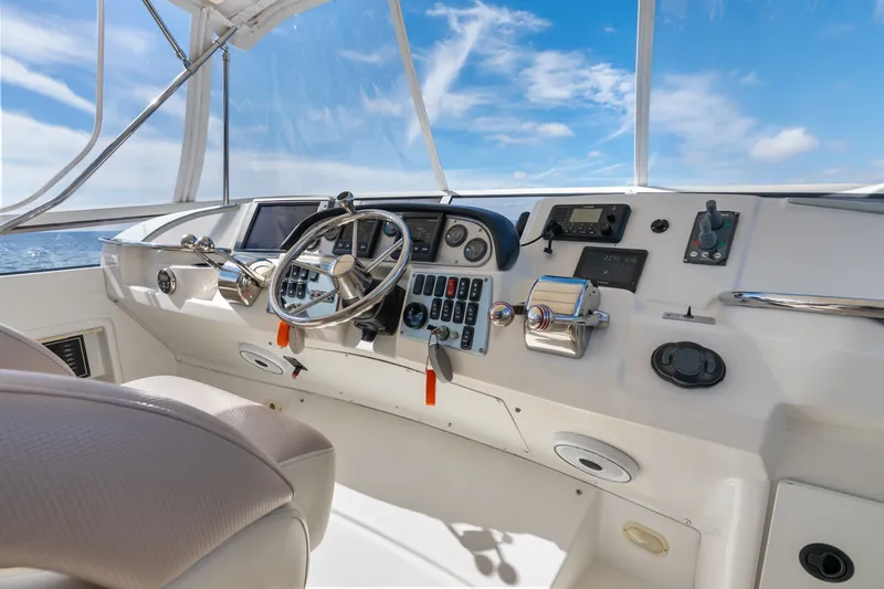 Slide: The Image of Cockpit of 2012 Carver 41 Cockpit Motor Yacht with steering wheel and controls. - 13