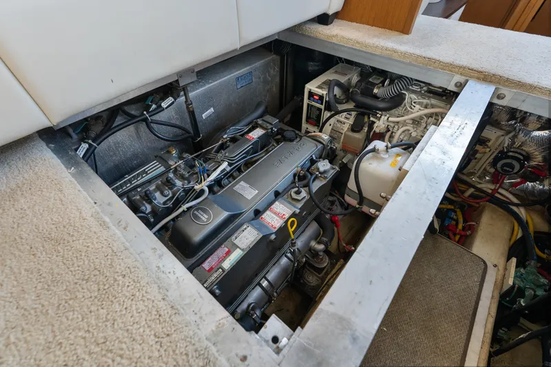 Slide: The Image of Engine compartment of a 2012 Carver 41 Cockpit Motor Yacht, showcasing mechanical components. - 49