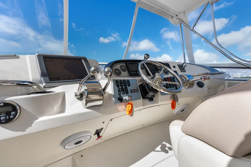Slide: The Image of Cockpit of 2012 Carver 41 Cockpit Motor Yacht with steering wheel and controls. - 14